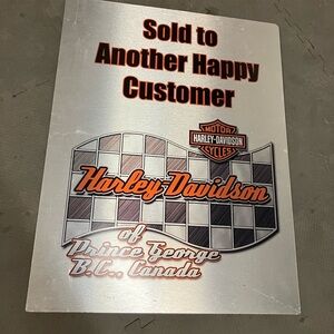 Harley Davidson metal sign.  “Sold to another happy customer”